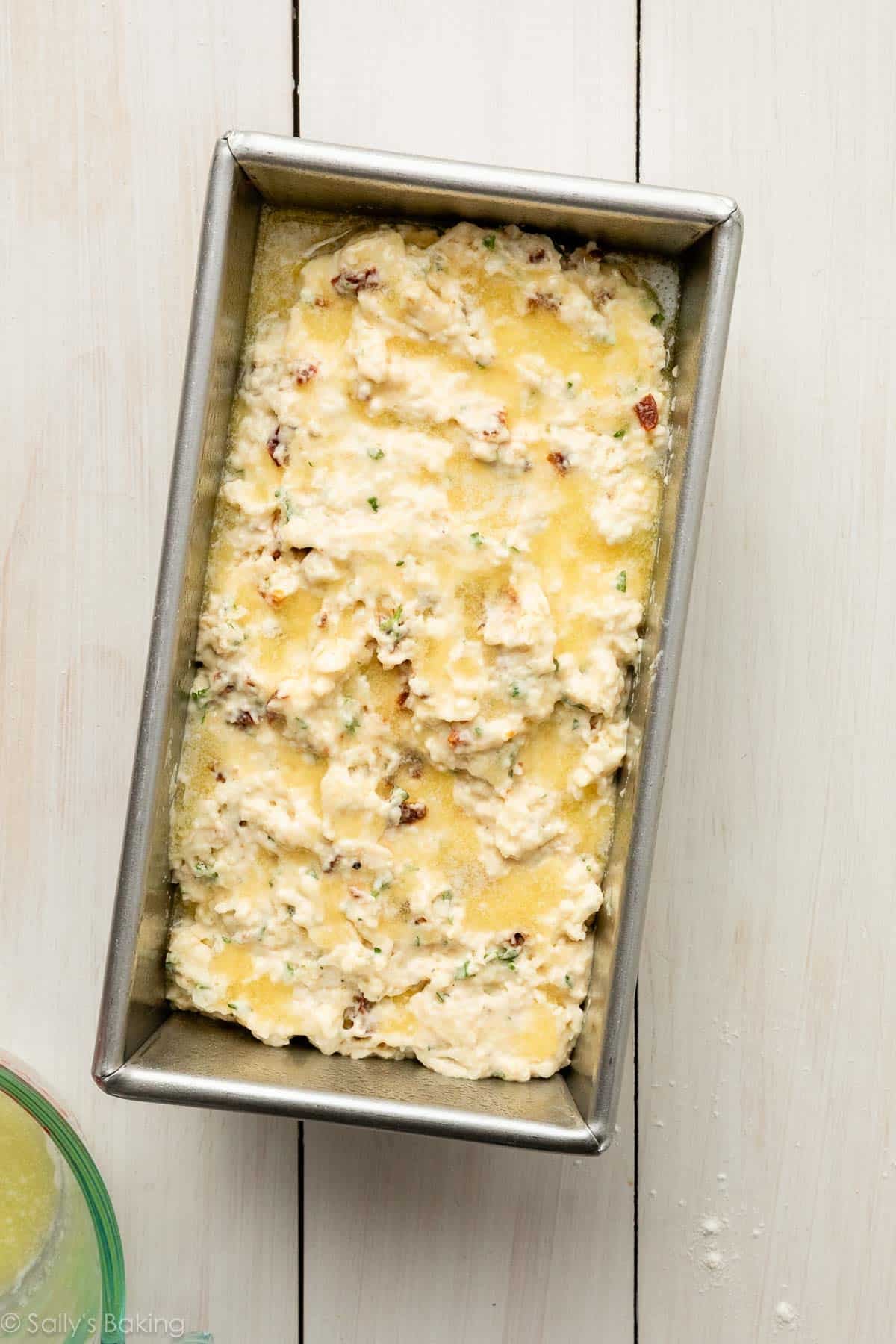 batter in loaf pan with melted butter.