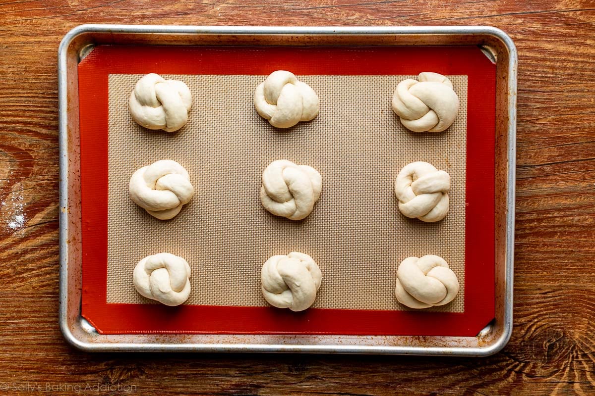 dough knots on baking sheet before baking soda bath