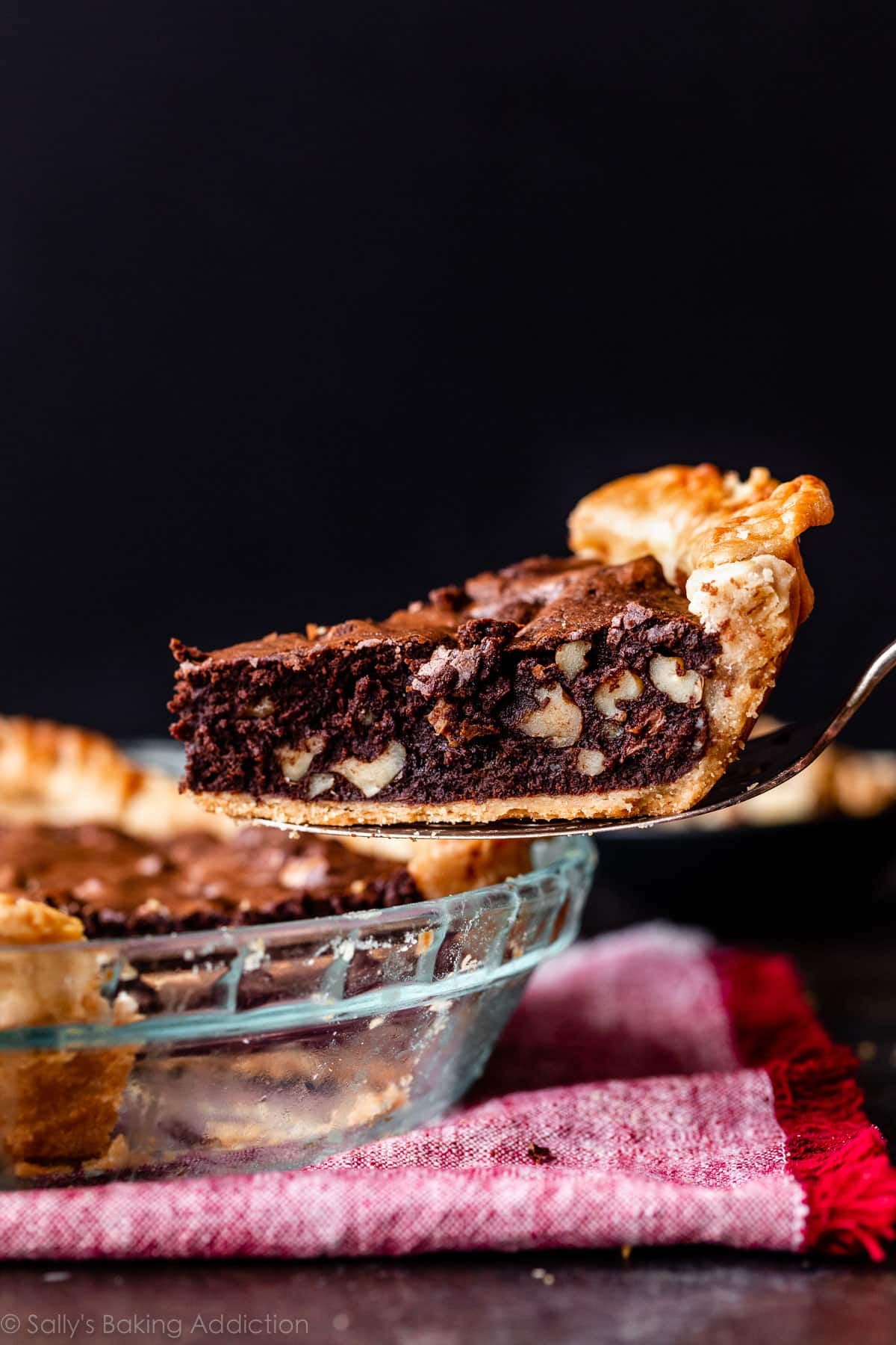 removing a slice of brownie pie from whole pie