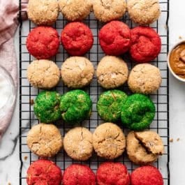 almond butter cookies rolled in white coarse sugar and red and green sanding sugar on cooling rack