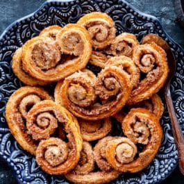 cinnamon spice palmier cookies on blue plate
