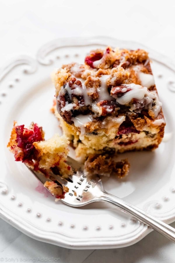 piece of cranberry pecan cake with orange glaze icing