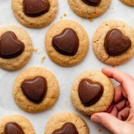 hand holding a peanut butter Valentine's Day cookie.