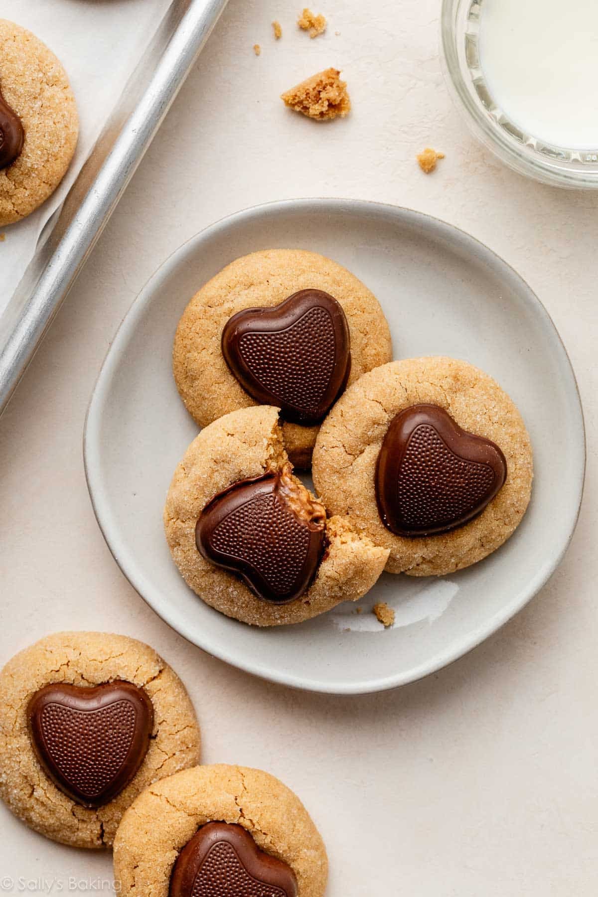 small plate with 3 peanut butter Valentine's Day cookies with chocolate hearts on top.