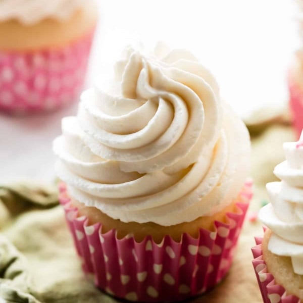 whipped frosting piped on cupcake