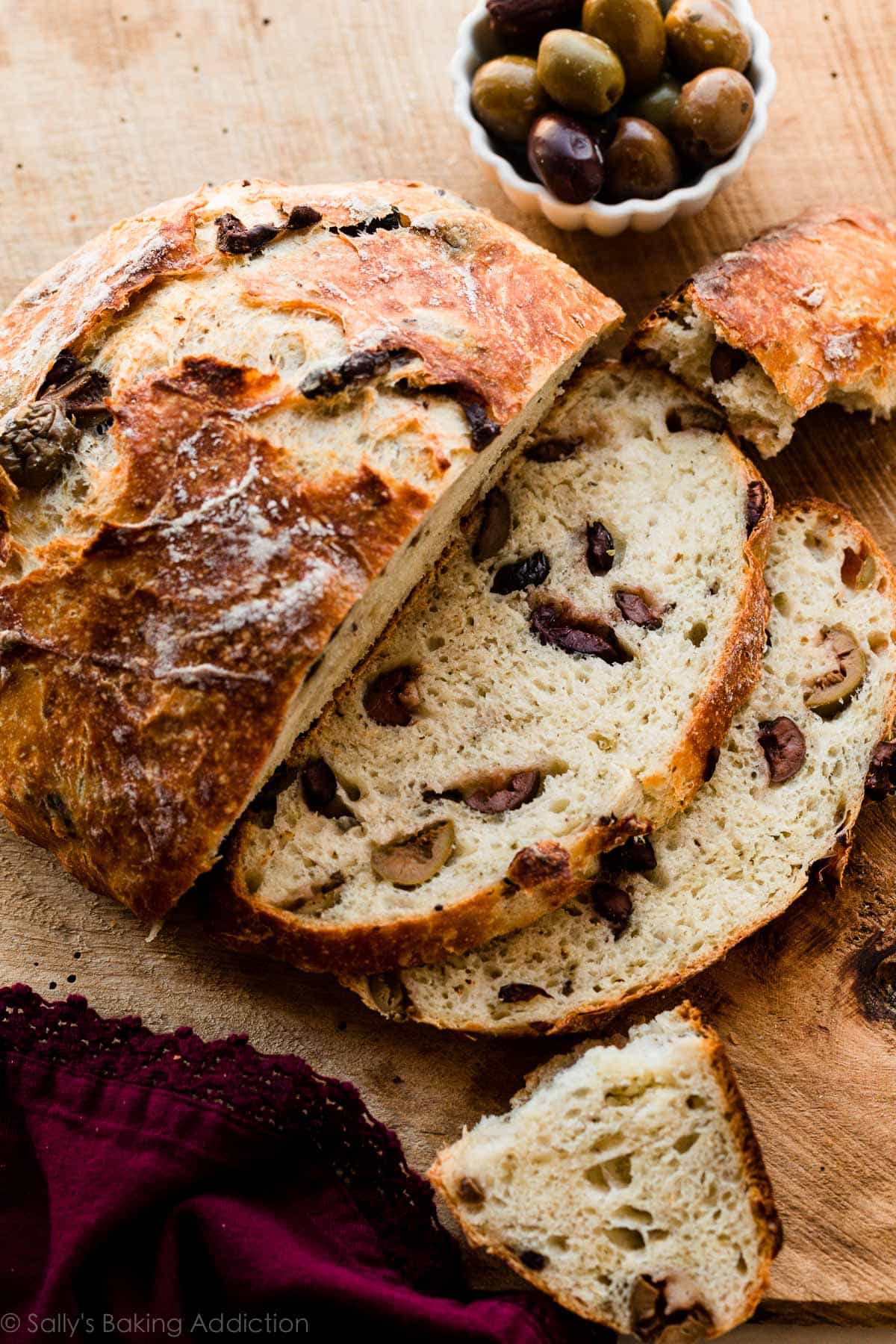 slices of olive bread shown with small bowl of olives