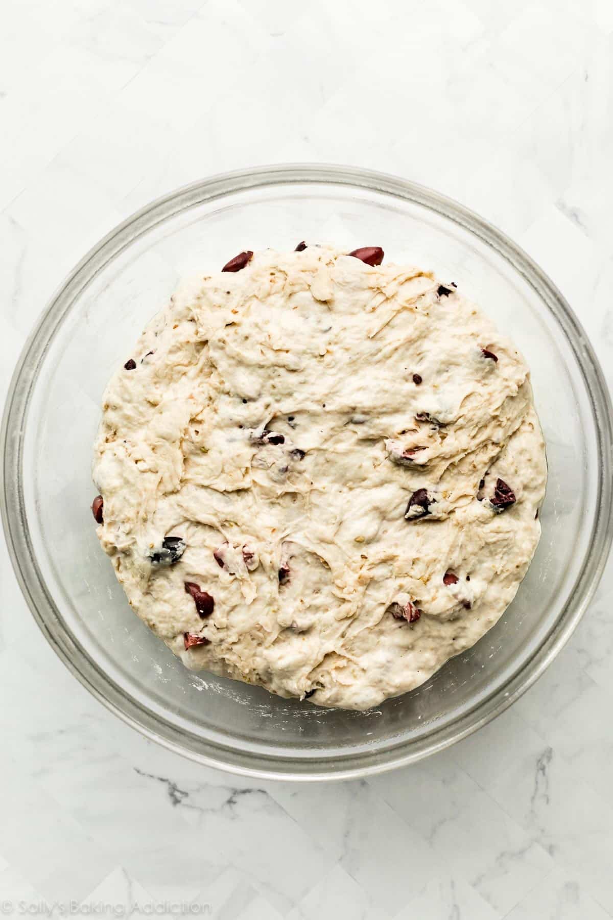 risen dough in glass bowl