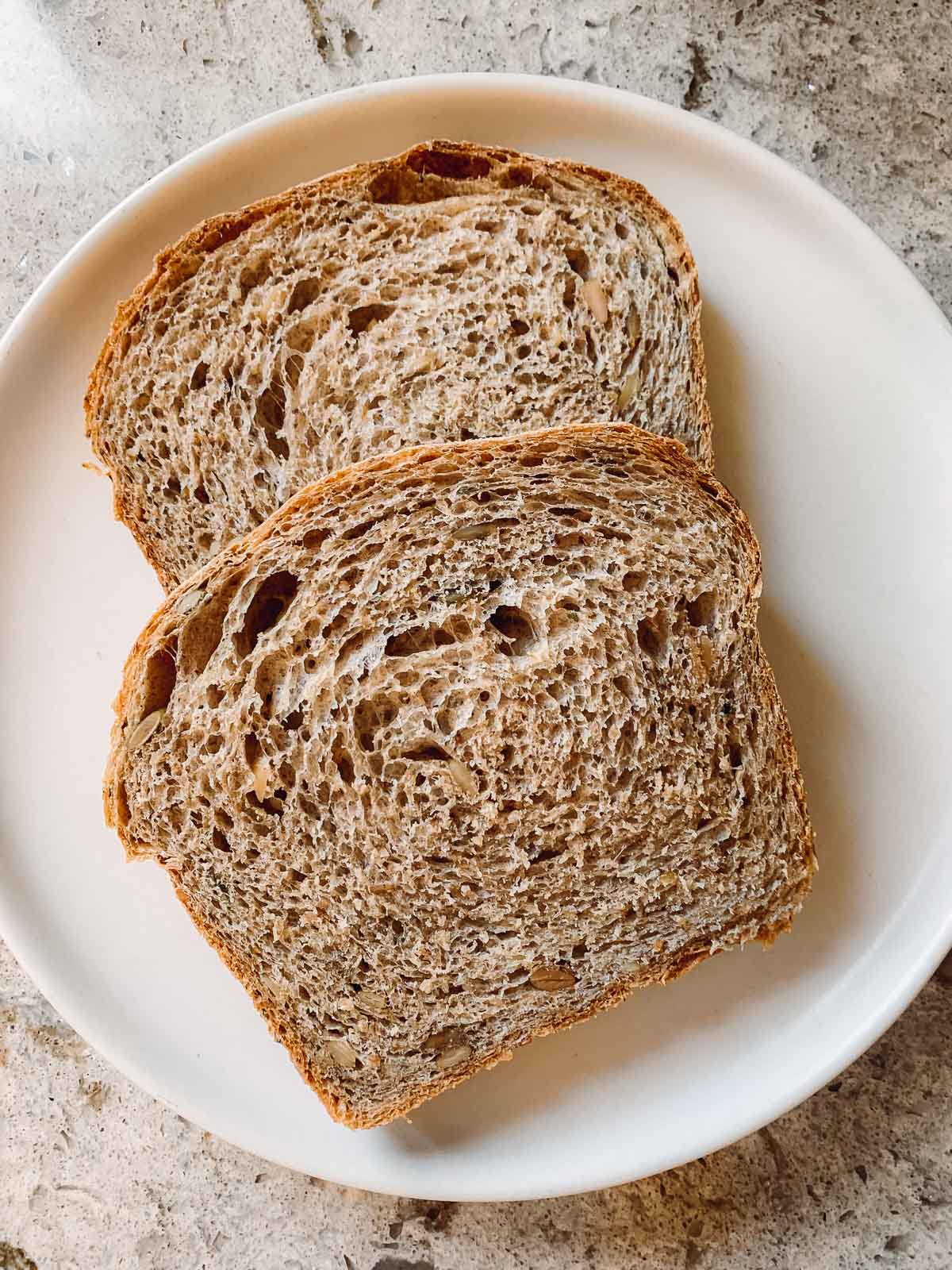 multigrain bread slices on white plate.