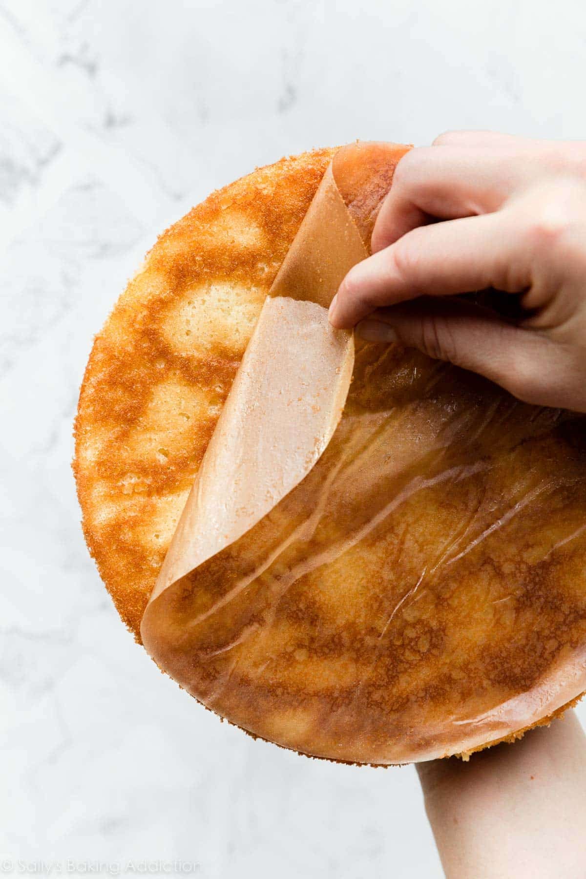 peeling parchment paper round off bottom of baked and cooled cake.