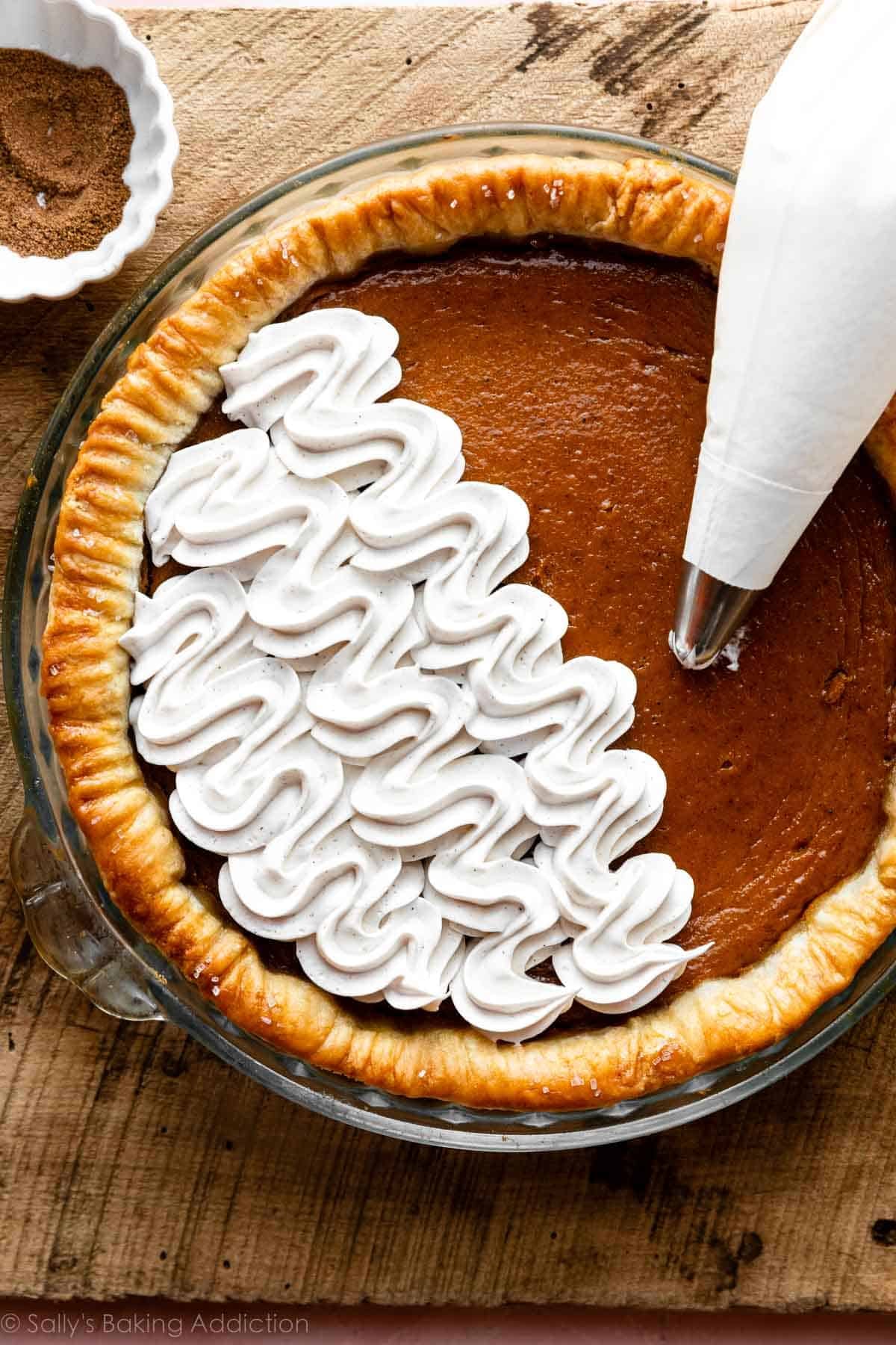 half of a pumpkin pie covered in piped meringue topping.