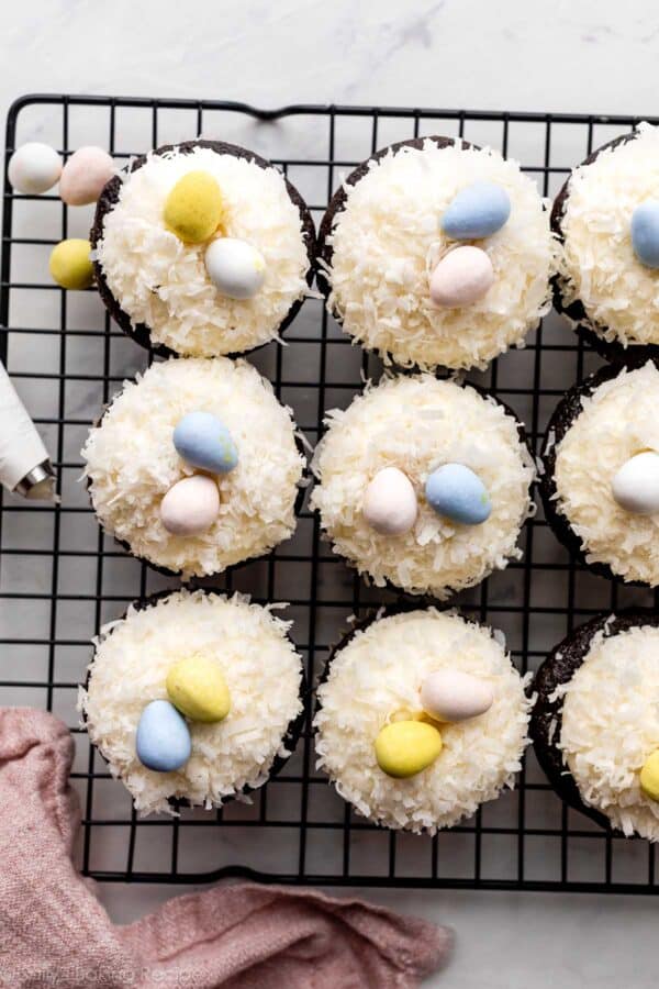 overhead photo of Easter cupcakes topped with coconut and chocolate egg candies.