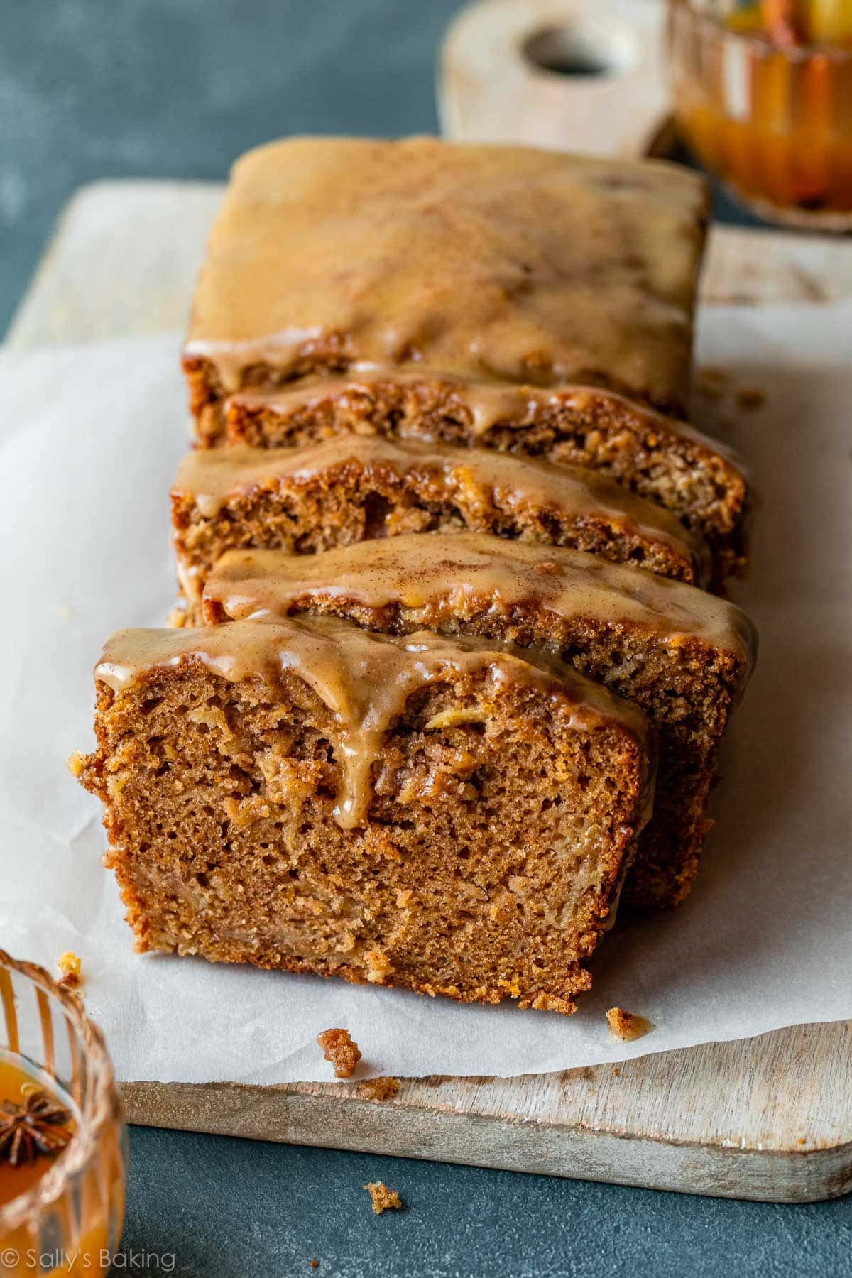 apple cider quick bread with icing on top.