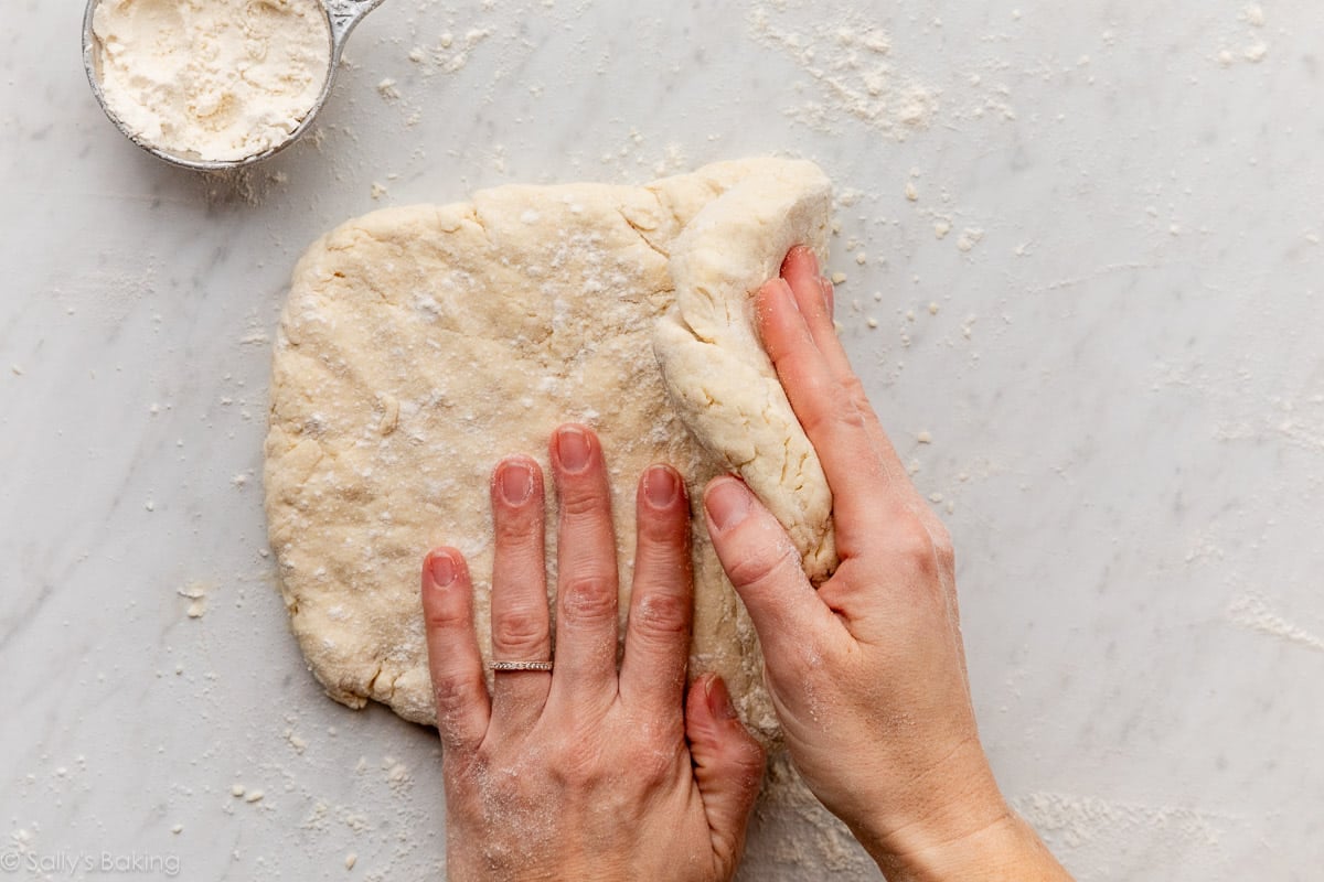 hands folding dough.