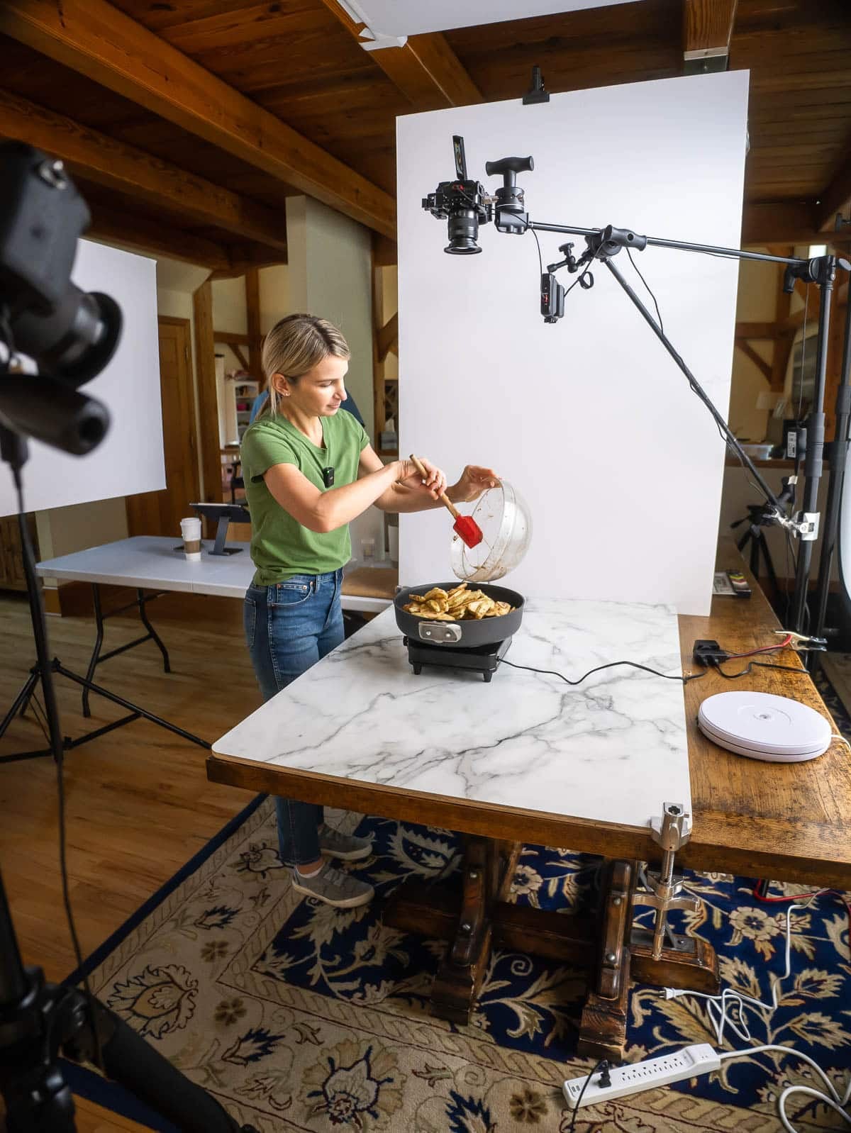 Sally pouring apples into pan on camera set.