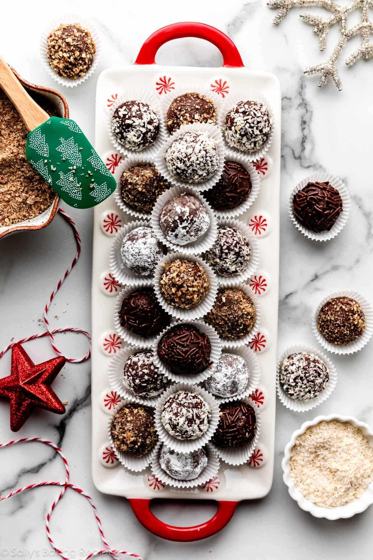 rum balls in mini muffin cup liners on Christmas plate with red handles.