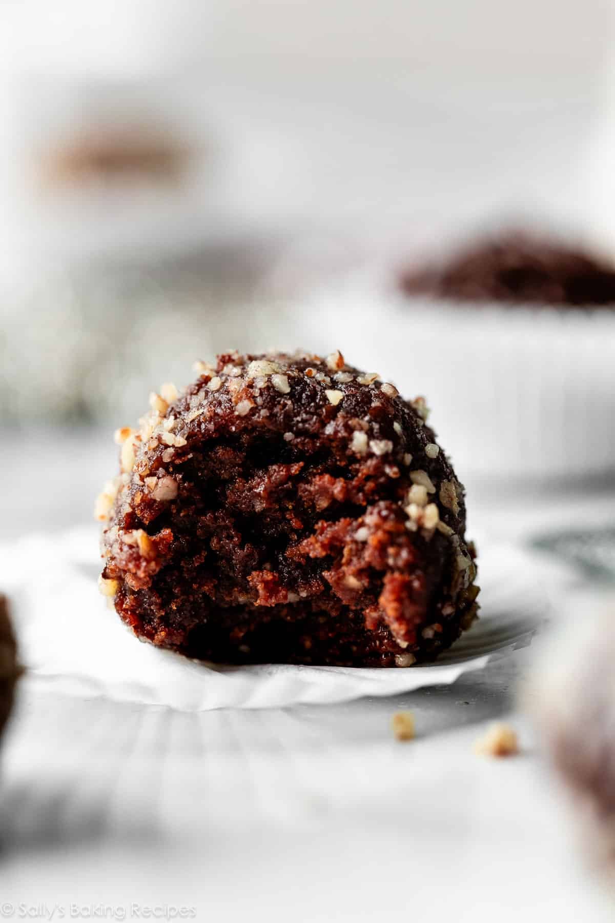 close-up of rum ball with bite taken out.