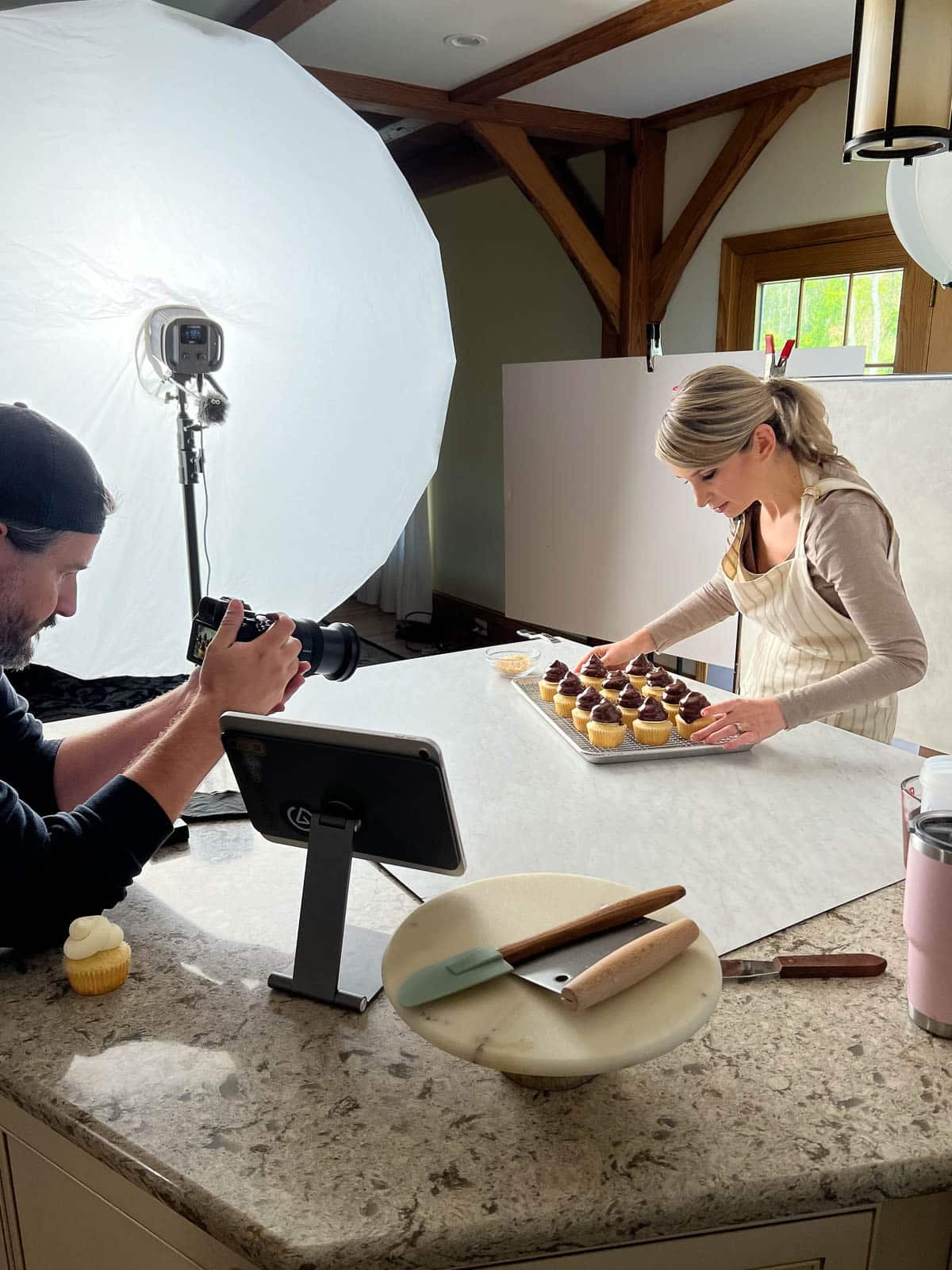 behind the scenes photo of Sally with chocolate-topped cupcakes.