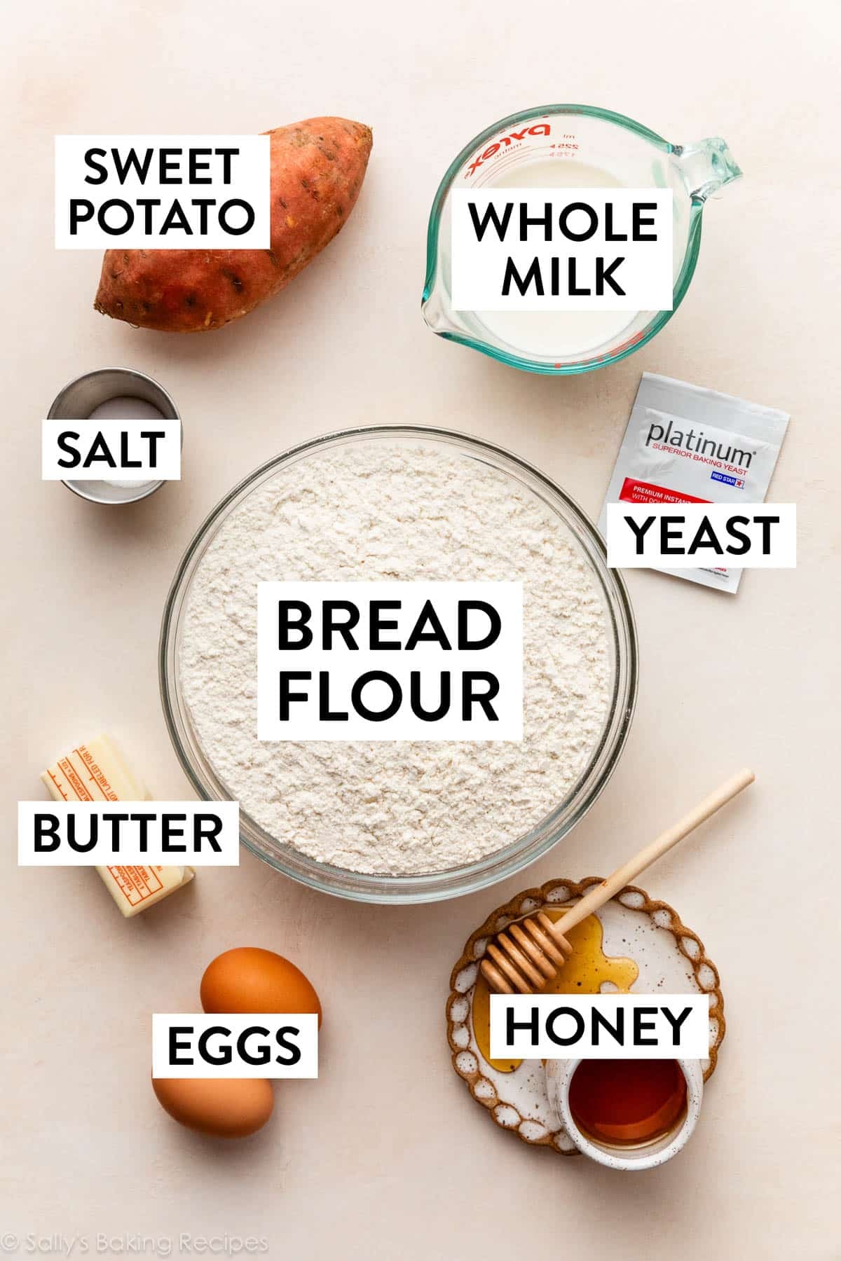 ingredients on peach surface including flour, whole milk, sweet potato, butter, and eggs.
