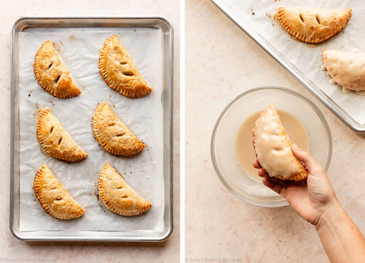 baked hand pies on parchment paper-lined baking sheet and hand dipping one in glaze.