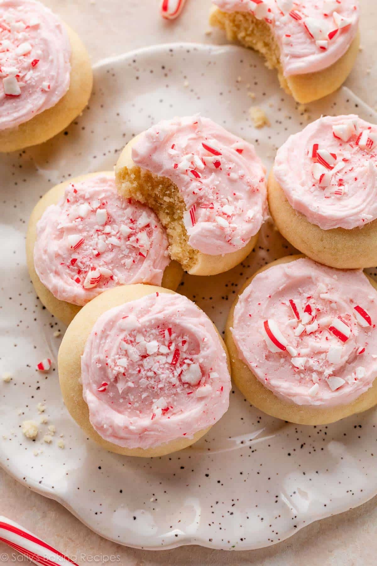close-up of frosted peppermint meltaway cookies with one with bite taken out.