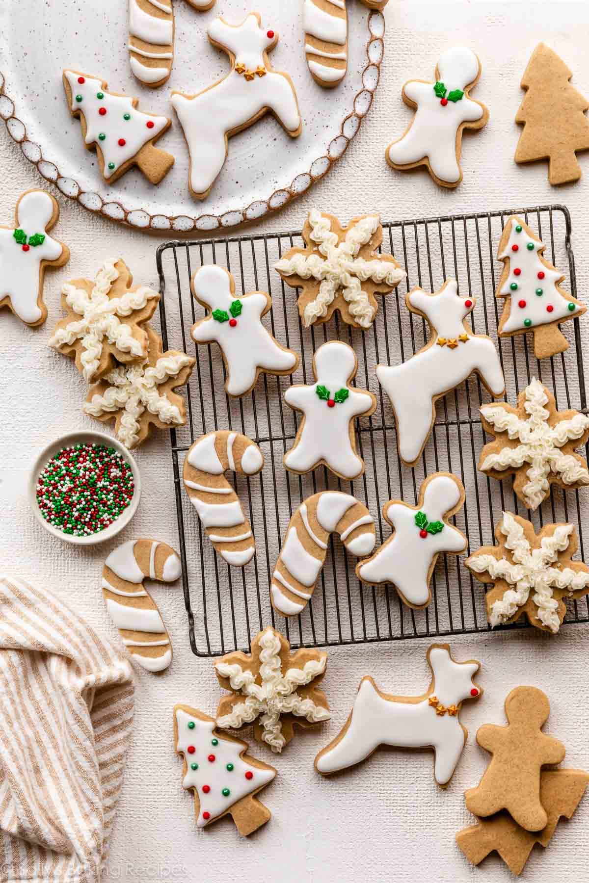 decorated brown sugar cut out cookies with white icing and Christmas sprinkles.