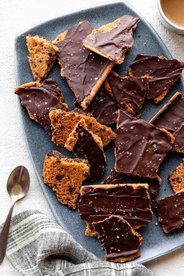 chocolate chip cookie bark with chocolate and sea salt on top pictured on blue plate.