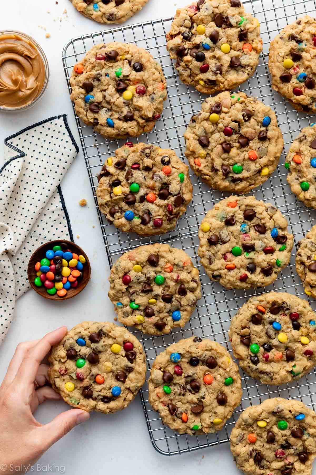 monster cookies on silver cooling rack.