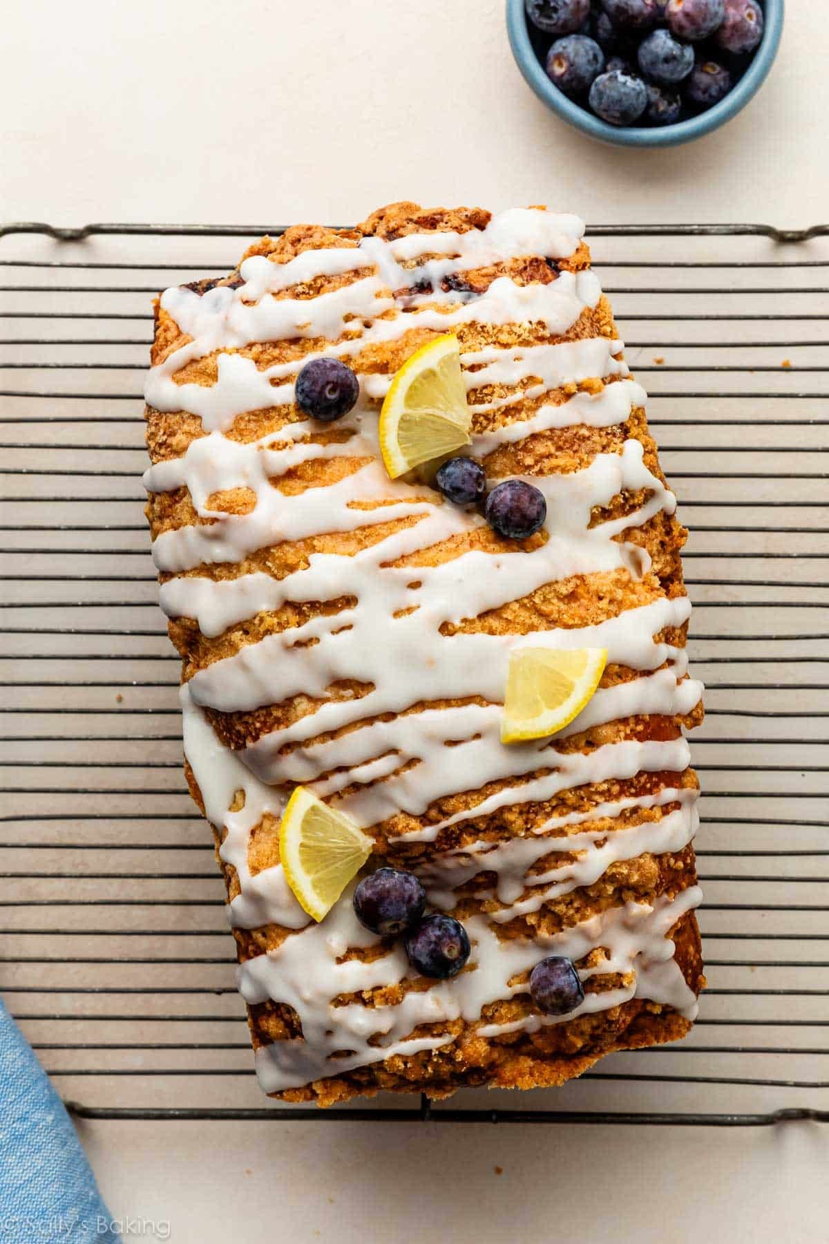 loaf of bread with icing and sliced lemons on top.