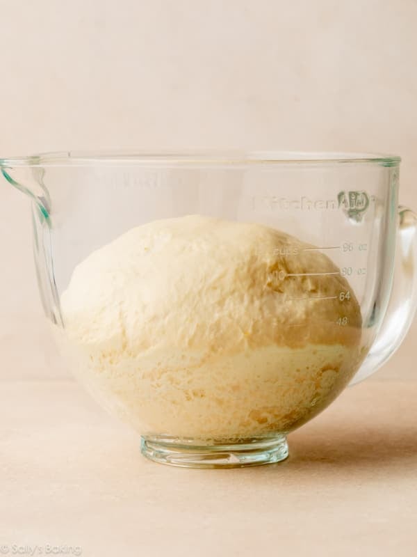 dough risen in glass bowl.