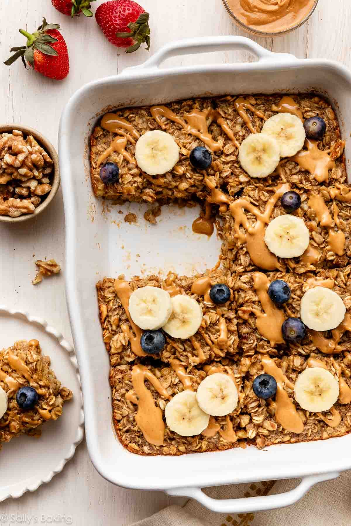 baked banana oatmeal with melted peanut butter, fresh blueberries, and banana slices on top.