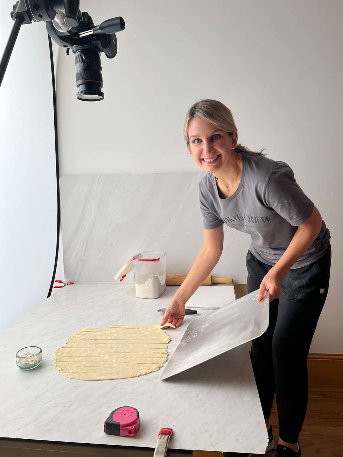 Sally smiling with pie dough.
