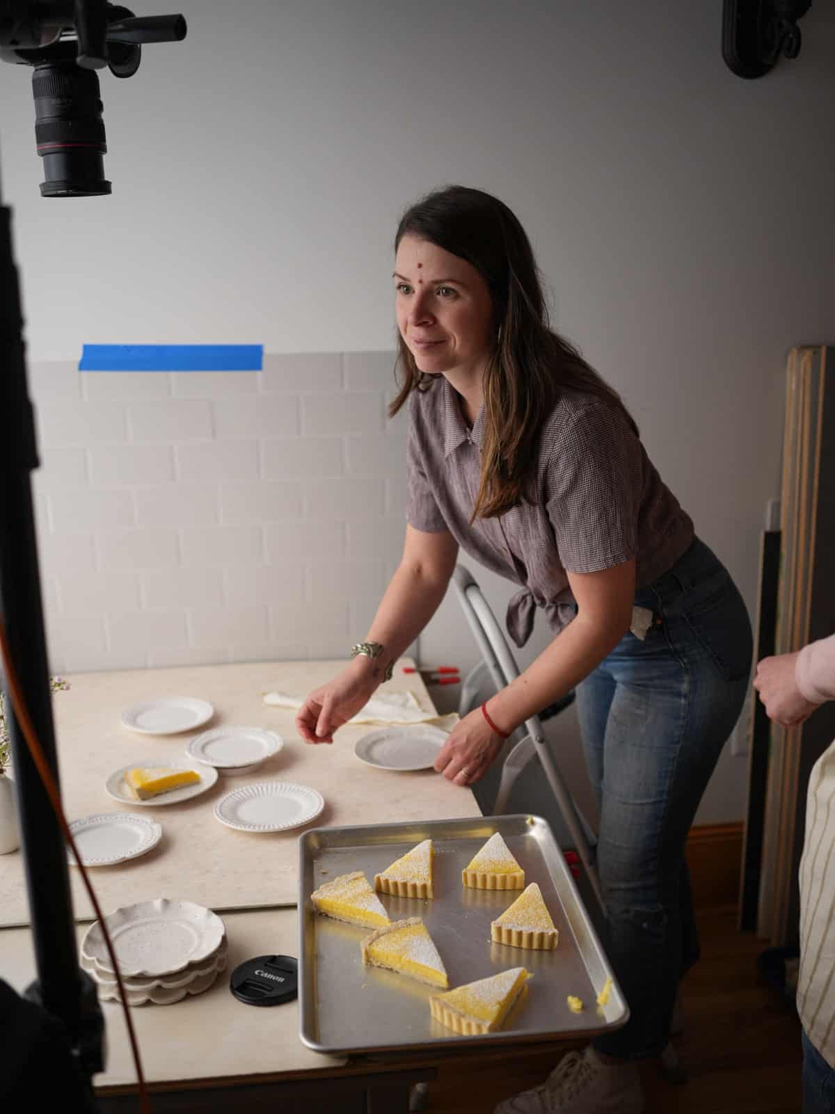 stylist arrange tart slices on plate.