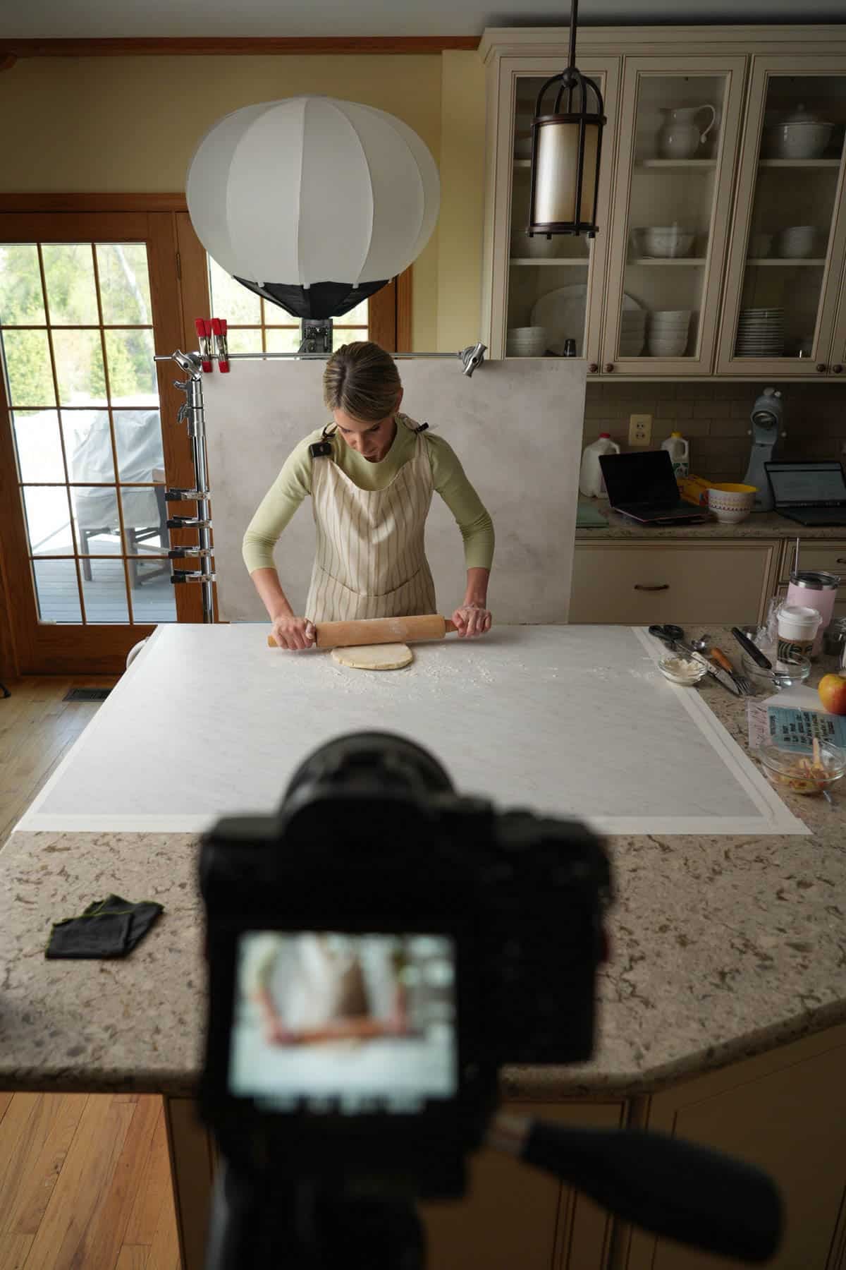 Sally rolling out pie dough.