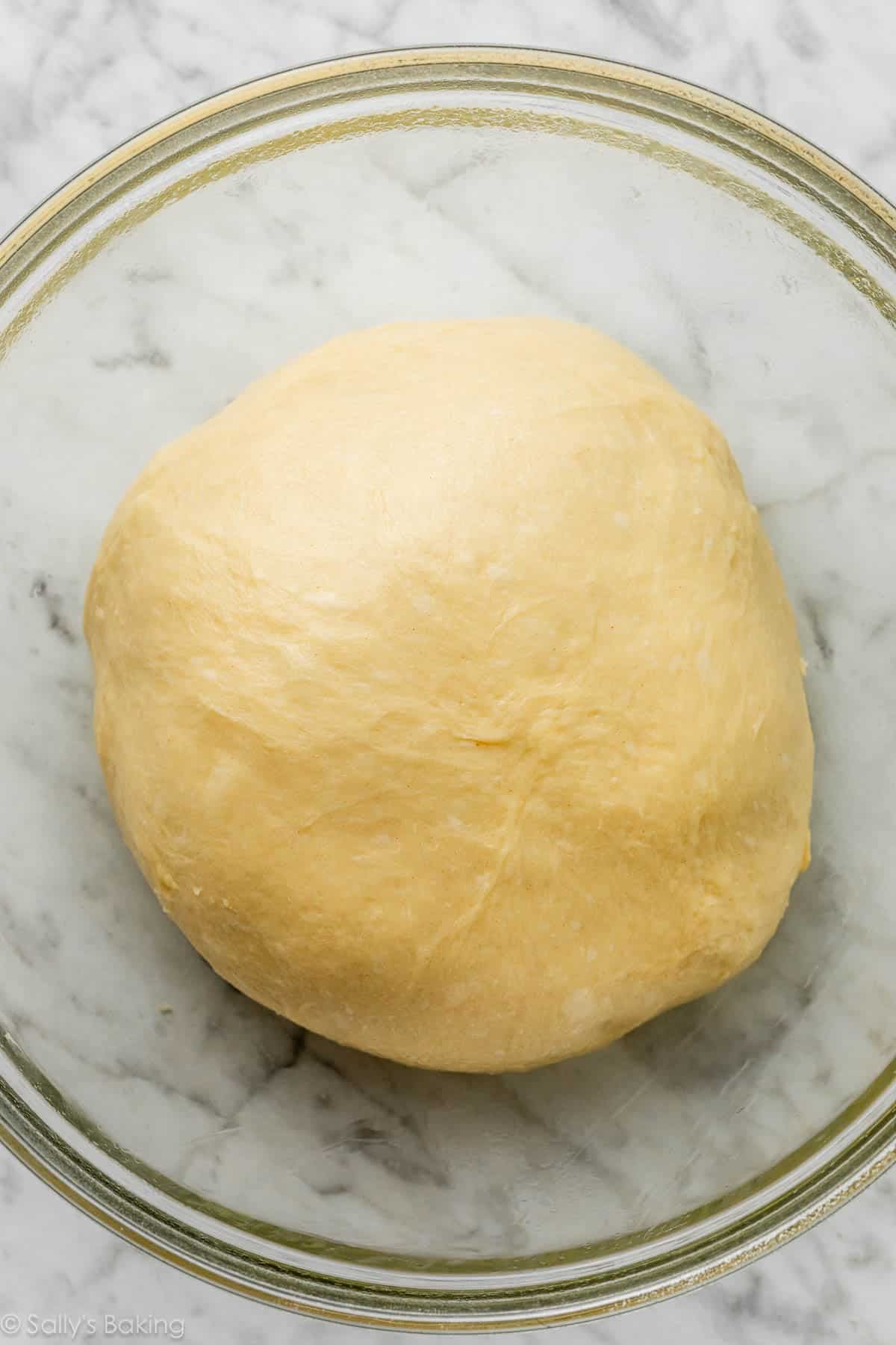 dough in glass bowl.