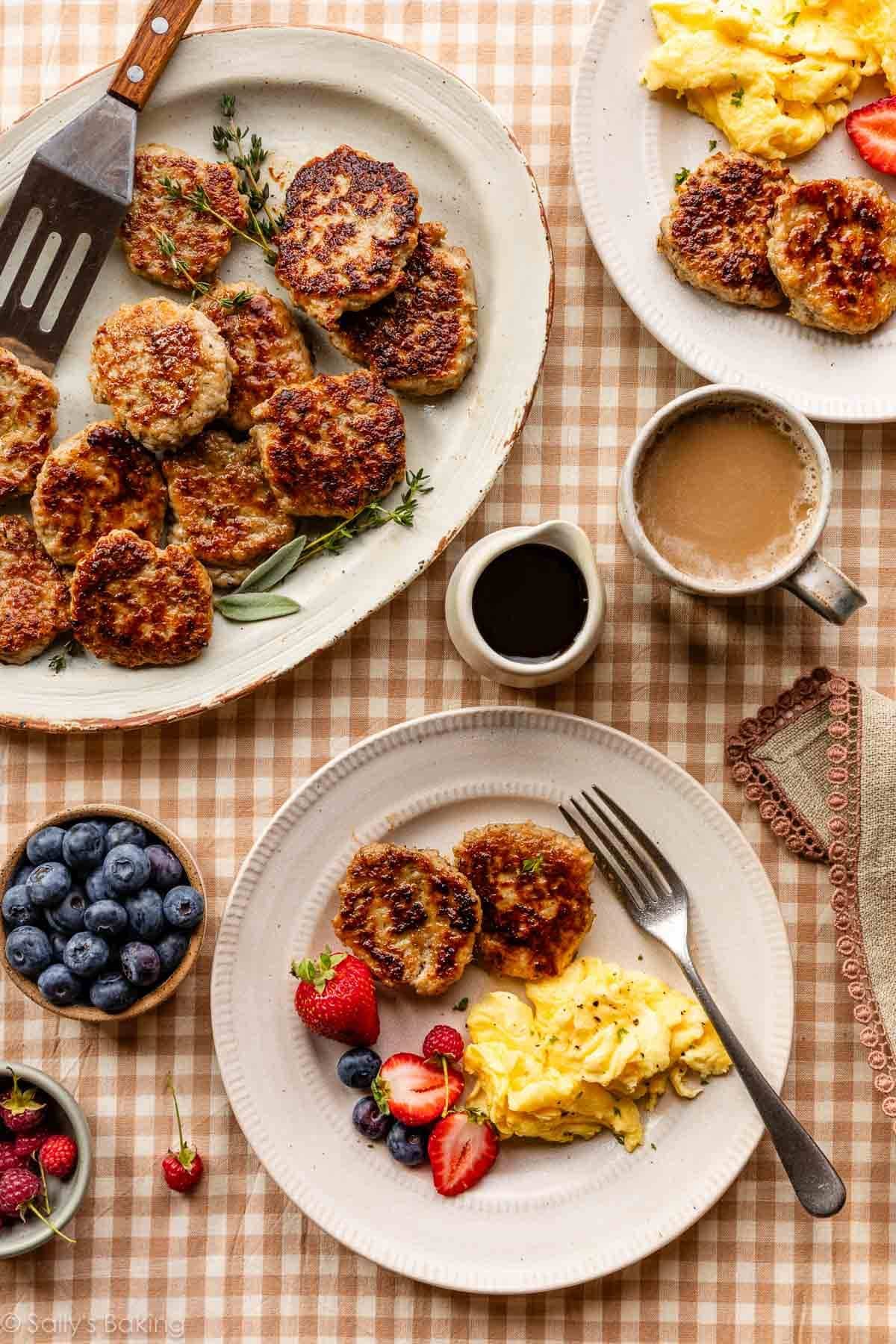 breakfast spread with homemade chicken sausage patties, scrambled eggs, fresh fruit, and coffee.