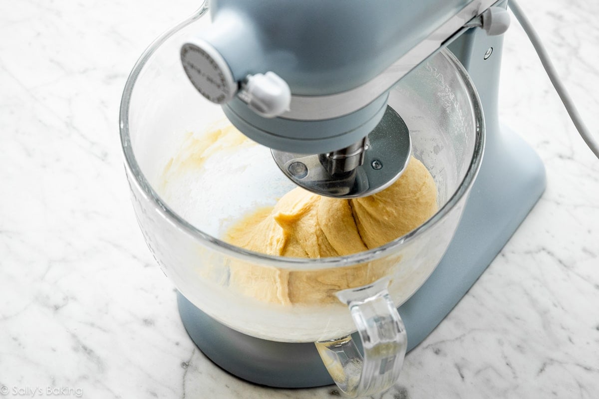 blue stand mixer mixing dough.