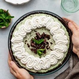 hands holding creme de menthe mint chocolate pie.
