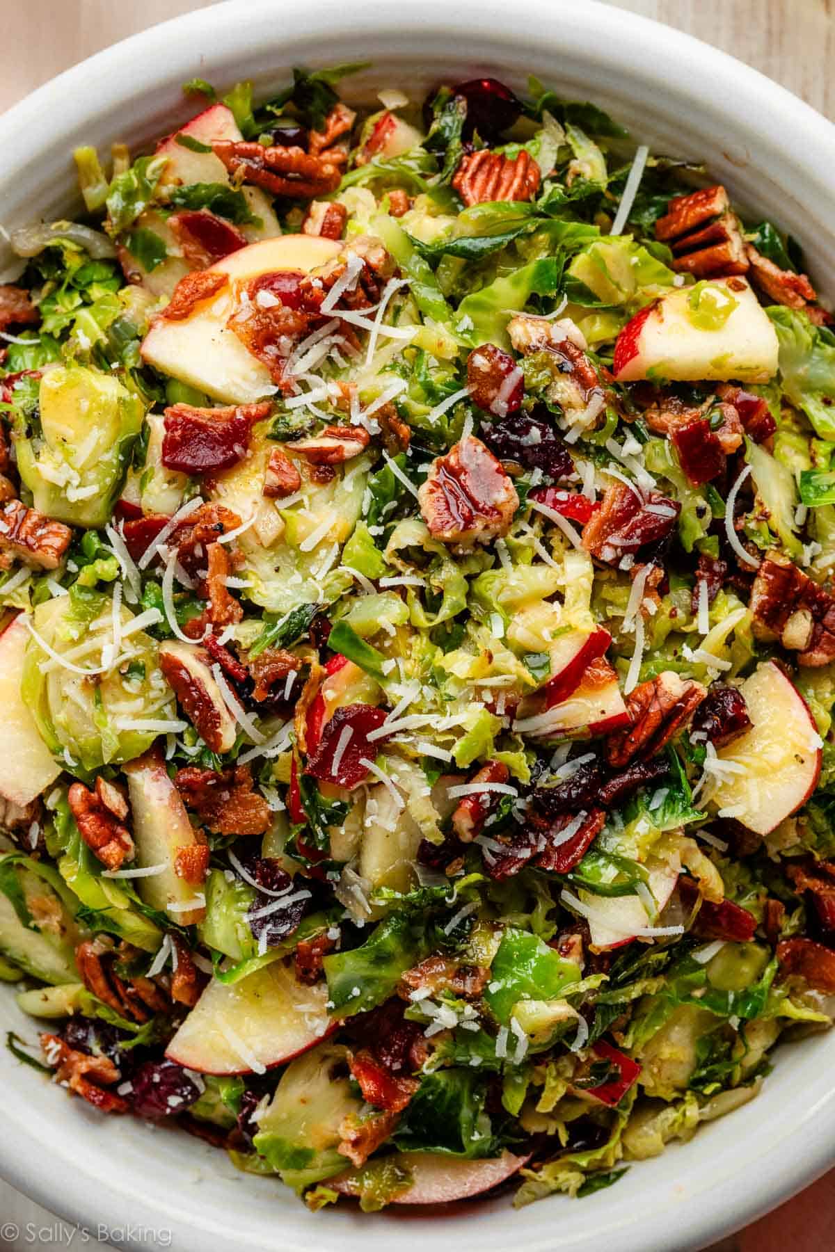 Brussels sprouts salad with bacon, apple, dried cranberries, pecan, and parmesan cheese.