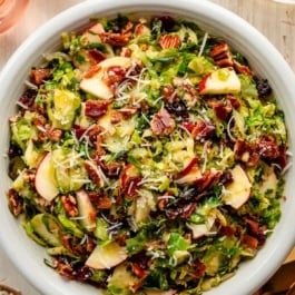 Brussels sprouts salad with bacon, apple, dried cranberries, pecan, and parmesan cheese.