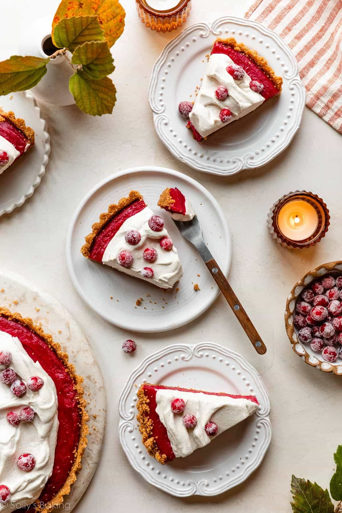 cranberry curd tart slices on white plates.
