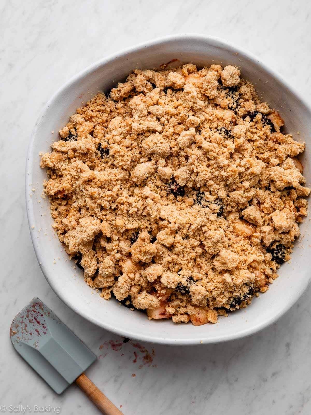 crumble topping in white serving dish.