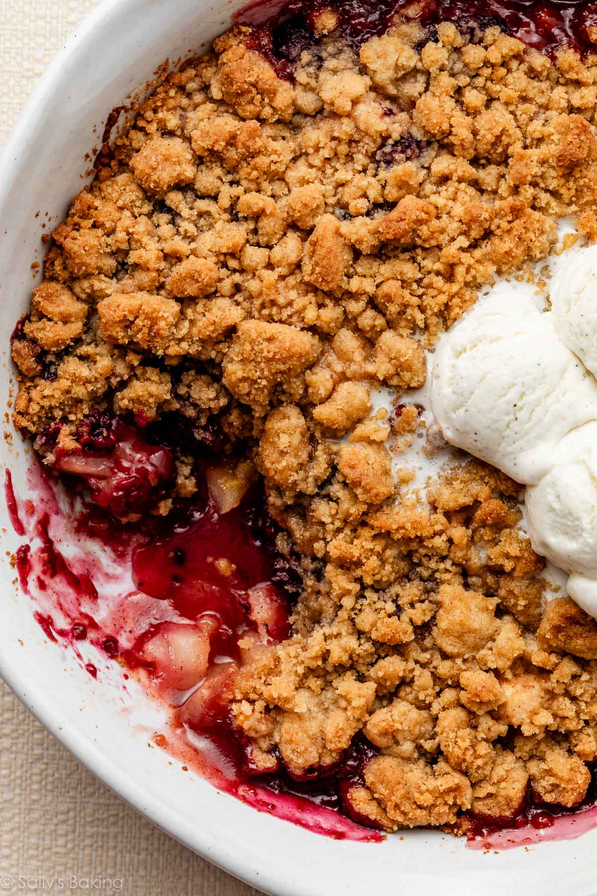 pear blackberry crumble with vanilla ice cream on top.