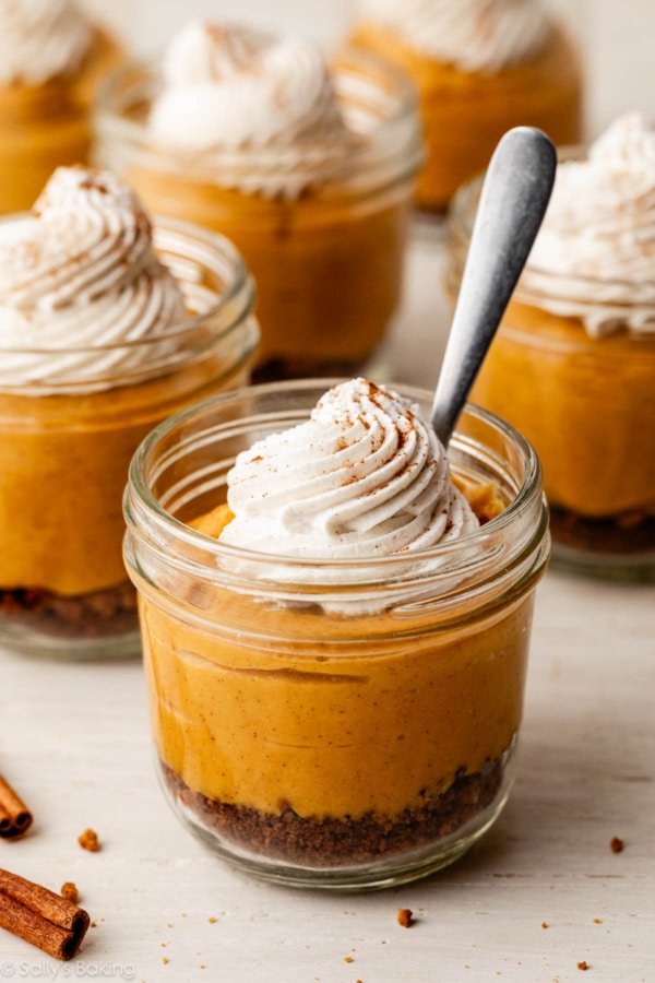 pumpkin pie in a jar with whipped cream.
