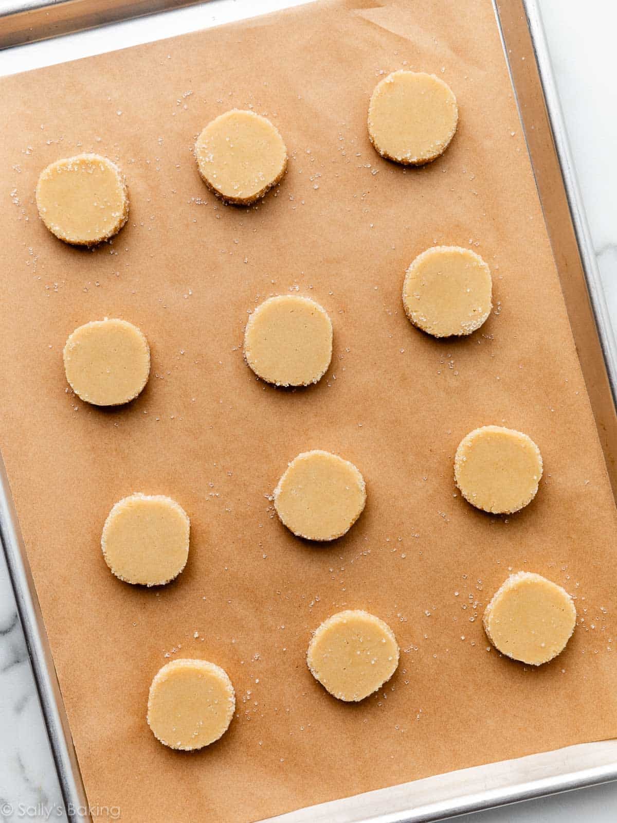 sliced cookies on parchment paper-lined baking sheet.