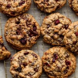 big fat dark chocolate cranberry oatmeal cookies on cooling rack.