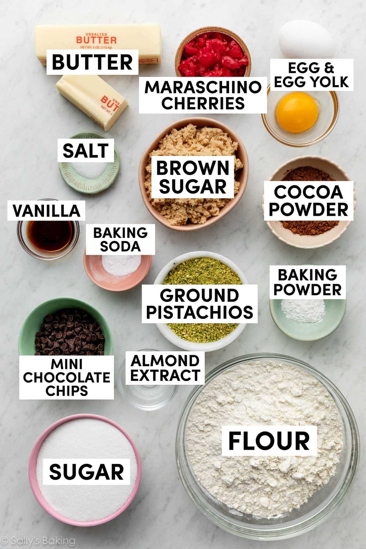 ingredients in bowls including maraschino cherries, sugar, brown sugar, flour, egg, and cocoa powder.