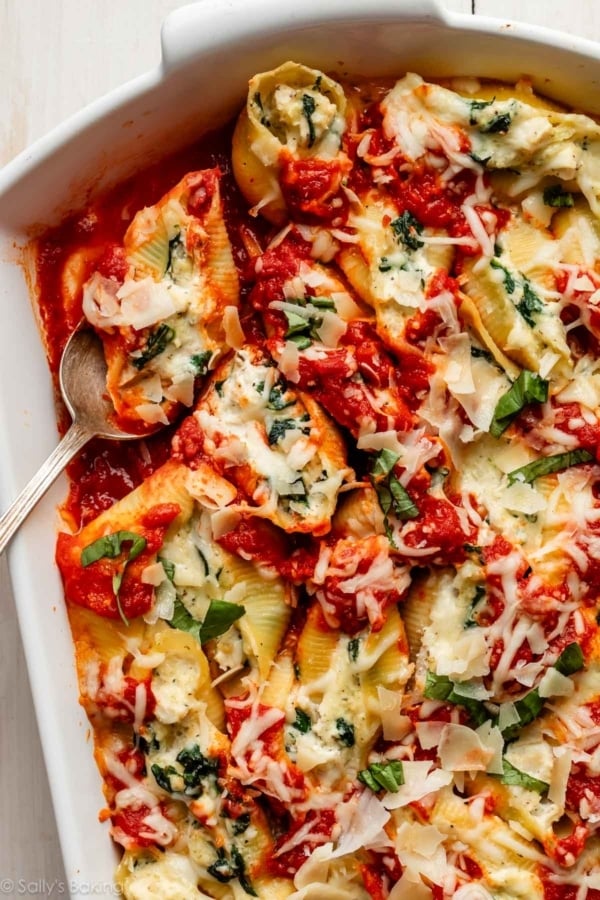 creamy chicken stuffed shells with marinara and garlic spinach.