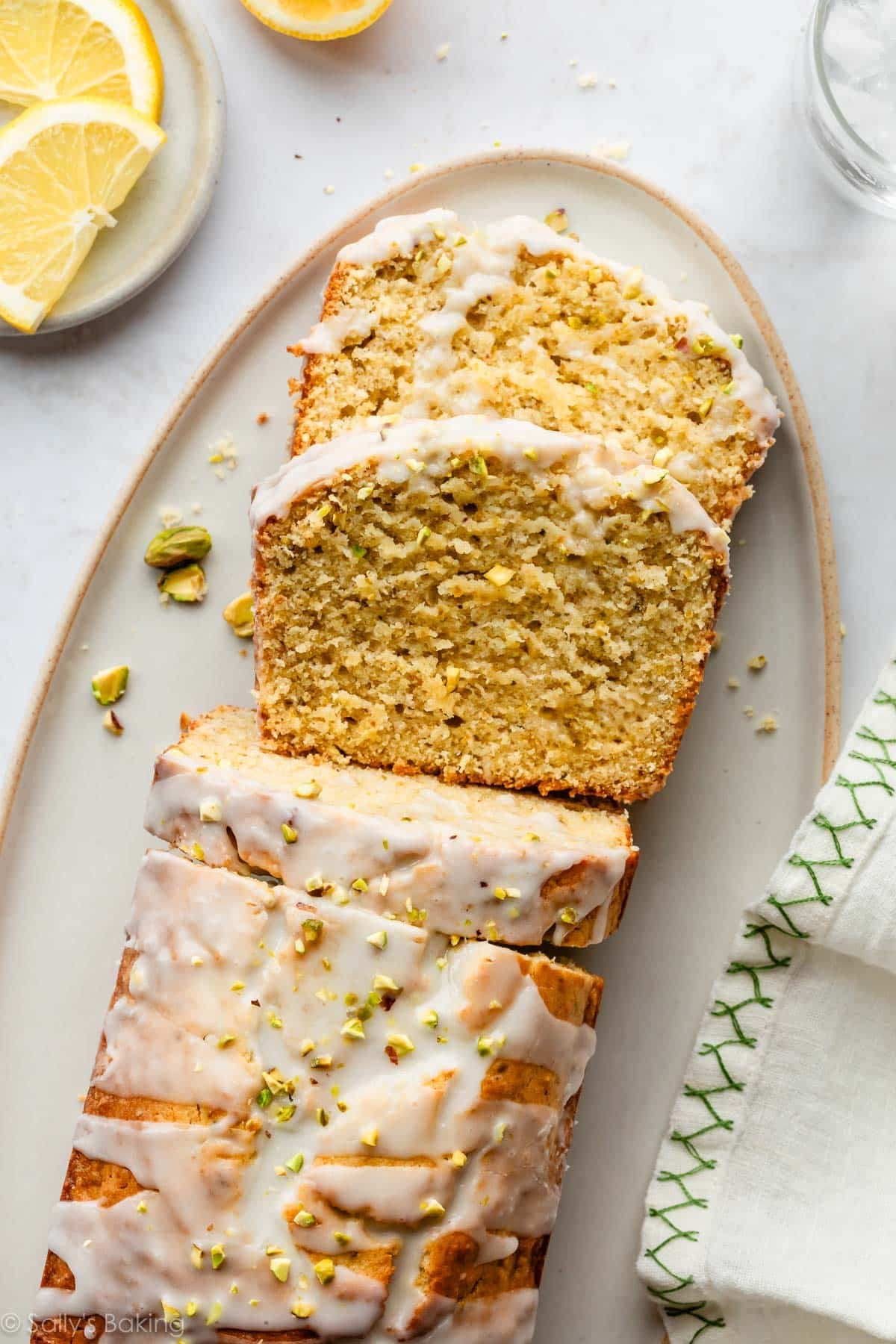 glazed lemon pistachio loaf cake on platter.