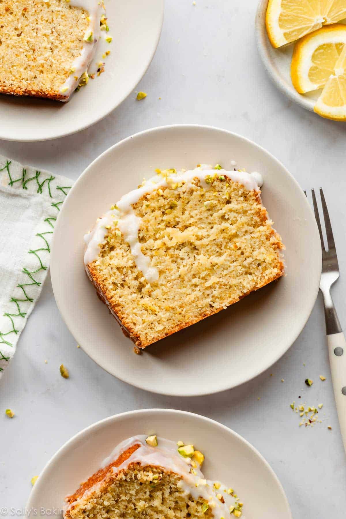 lemon pistachio loaf slices on plates.