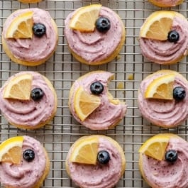 frosted lemon blueberry cookies on cooling rack.